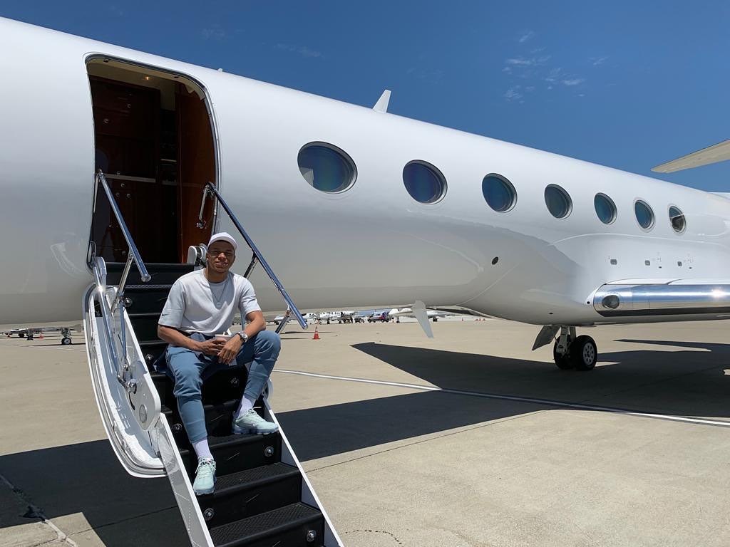 The footballer is snapped flying on a private jet