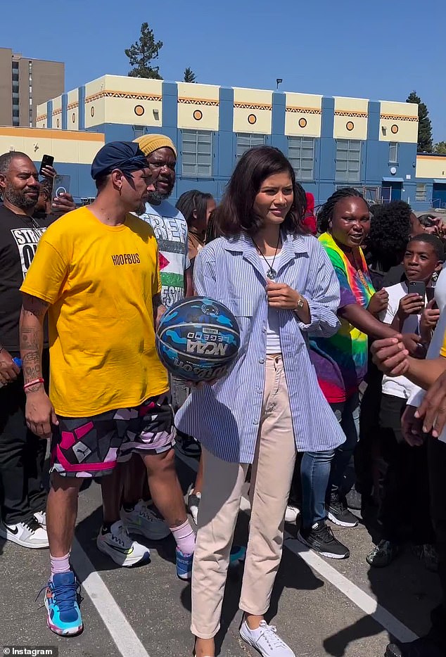 Playing ball: Zendaya and Tom Holland made a surprise visit to play basketball with some students in Oakland, California on Friday