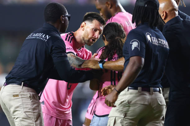 Lionel Messi of Inter Miami interacts with a fan that rushed the field during the second half of a game against the Colorado Rapids at DRV PNK...