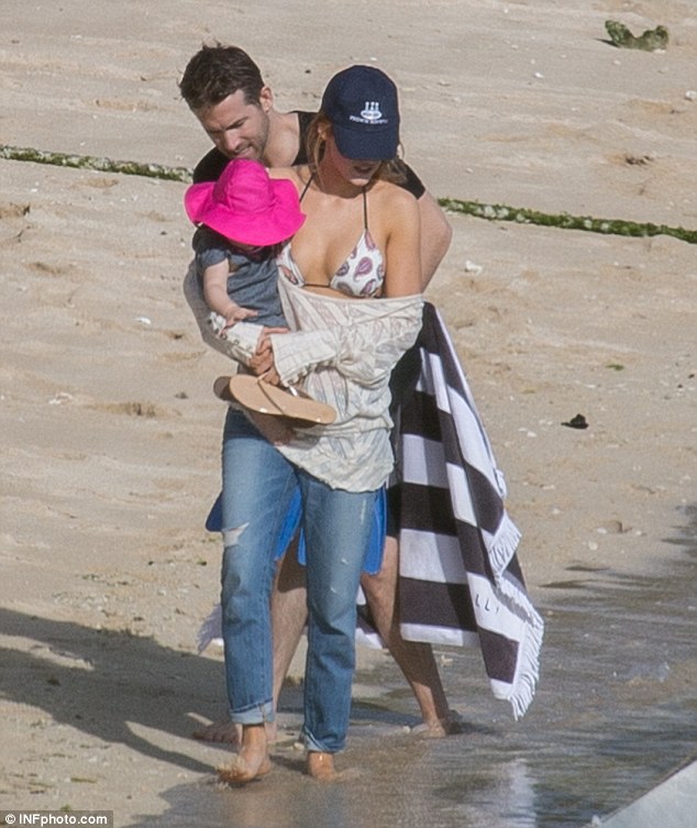 Following close behind: Ryan tried to catch up to his wife as she dipped her toes in the water