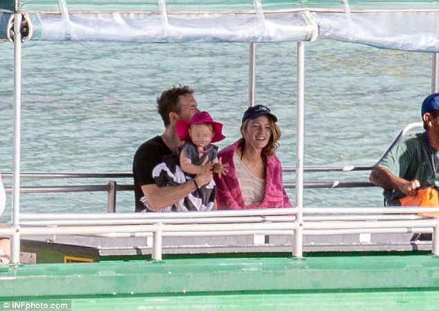 Safe in daddy's arms: The little girl played in Ryan's lap as Blake sat close beside him