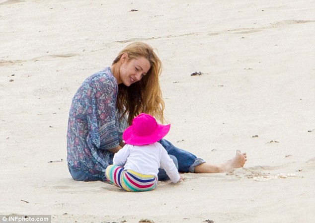 Mommy and me: Blake got her hands dirty in the sand