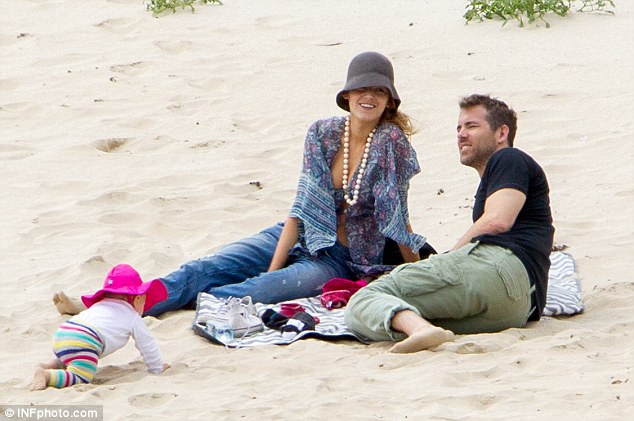 Family day: Blake and Ryan set up a blanket on the beach