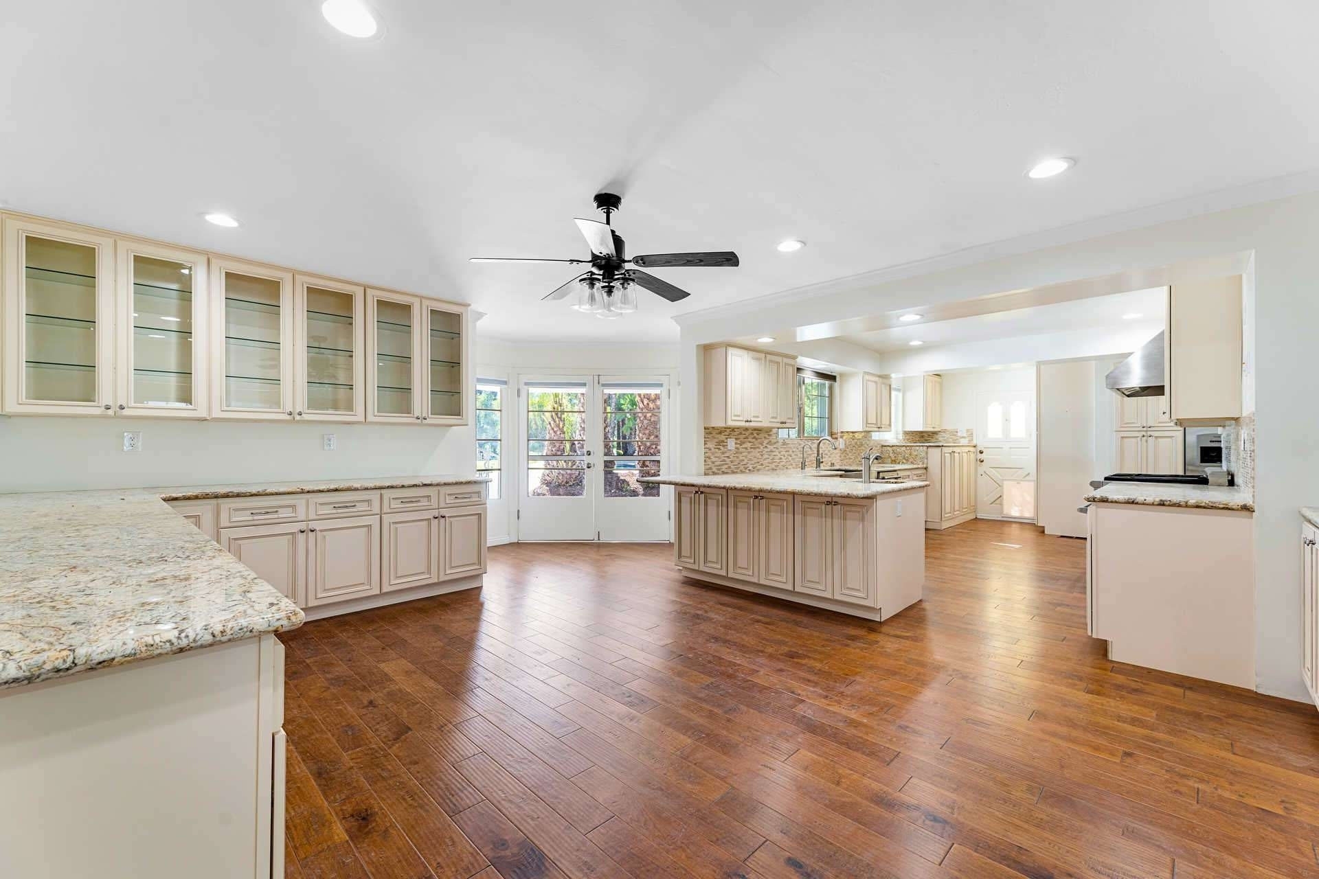  The kitchen has a neutral marble color theme with granite countertops