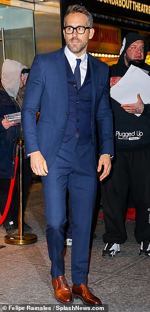 Suited and booted: Ryan, 42, certainly didn't let his wife down in the style stakes, and looked dapper as can be in an impeccably tailored navy blue three-piece suit