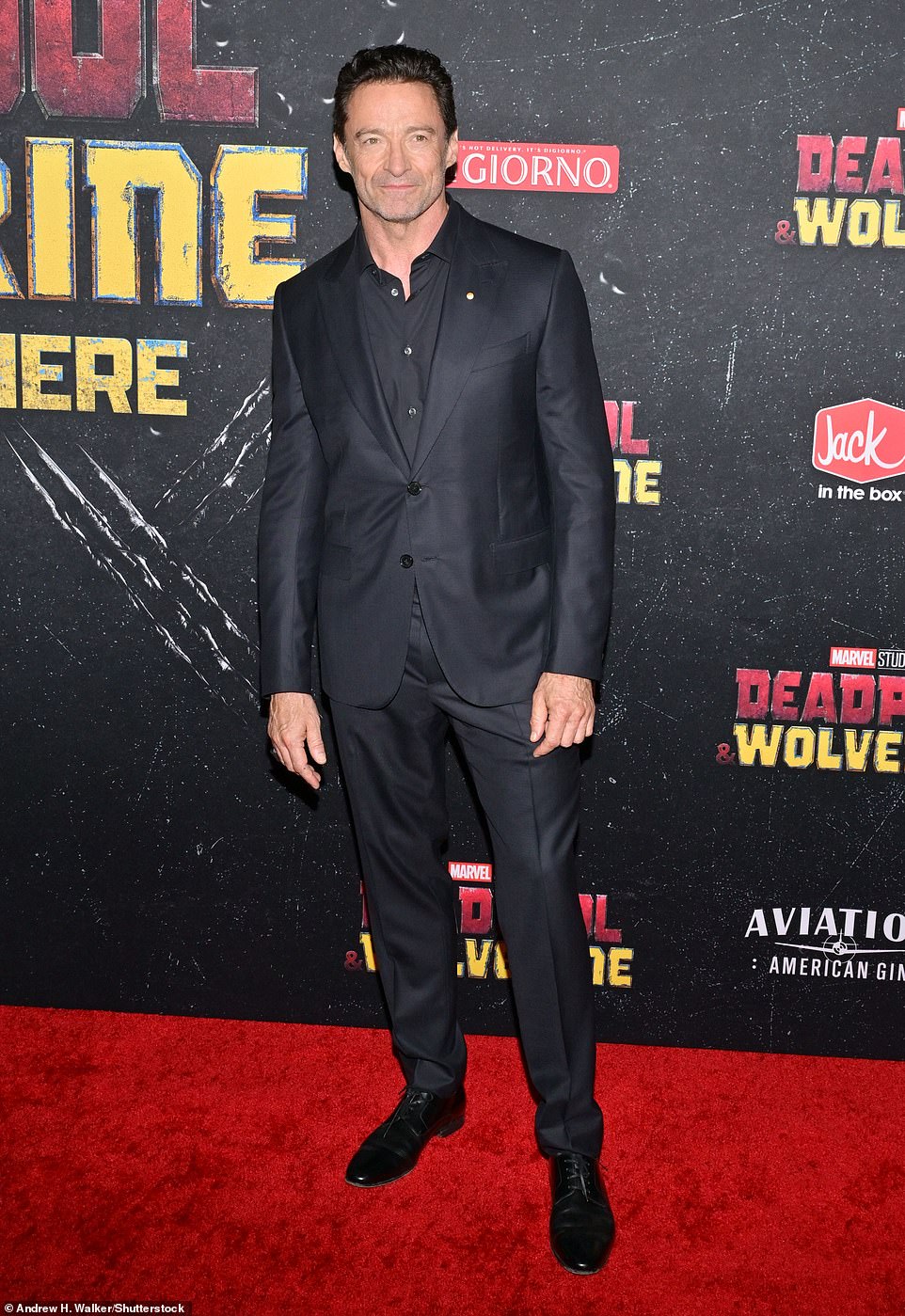 At the premiere, Jackman looked dapper in a monochromatic, dark gray outfit with a blazer matching his button-down and dress pants