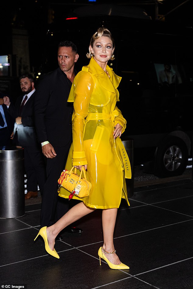 Gigi switched up her look and changed out of her yellow Miu Miu co-ord in favour of an eye-catching semi-sheer yellow trench