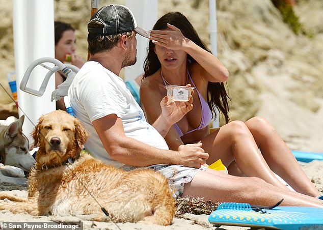 Bikini babe: Morrone was glowing in a lilac string bikini, which she paired with a gold necklace, Wearing her wavy hair down